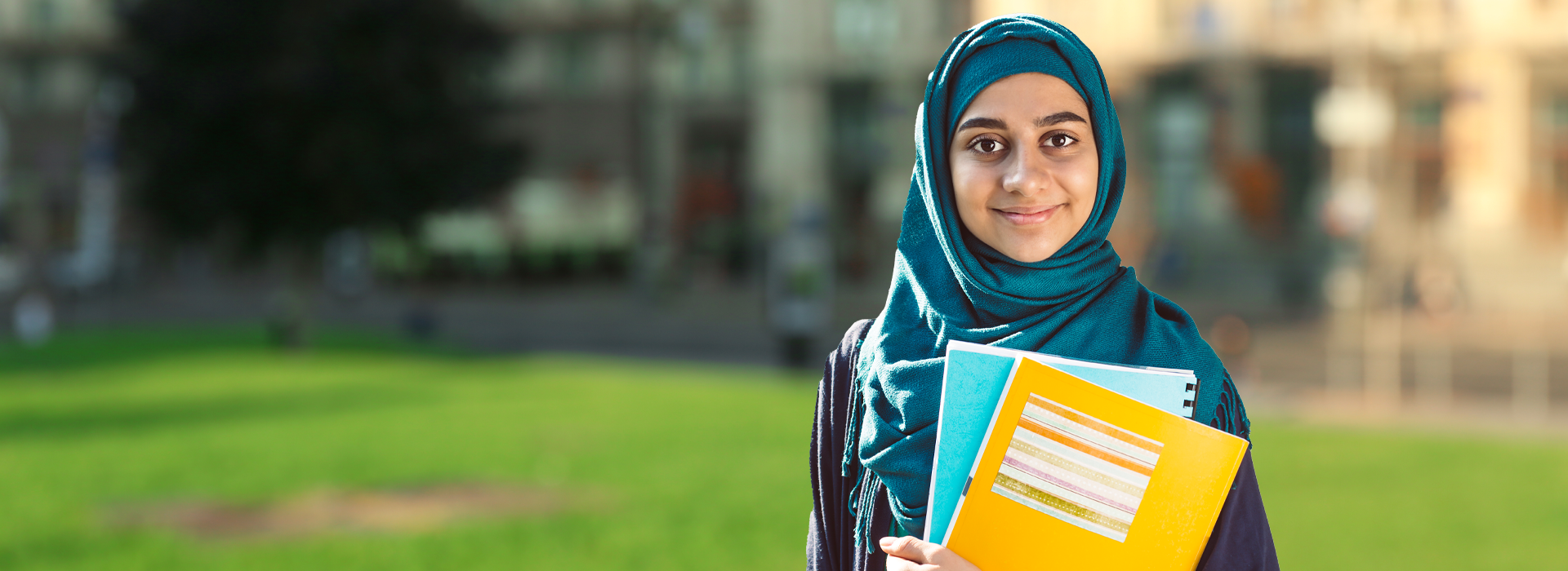 Pakistani hijabi girl smiling with school books - Easy Taleem online O Level & A Level school for girls